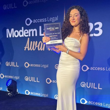 Modern Law Awards - Bell Lamb & Joynson Emily Oliver with award on stage